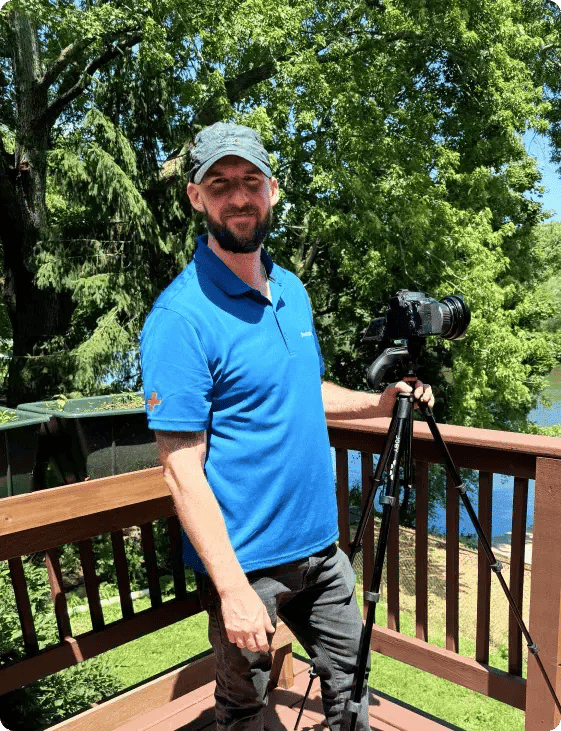 photographer Luke Regner standing with a camera and tripod