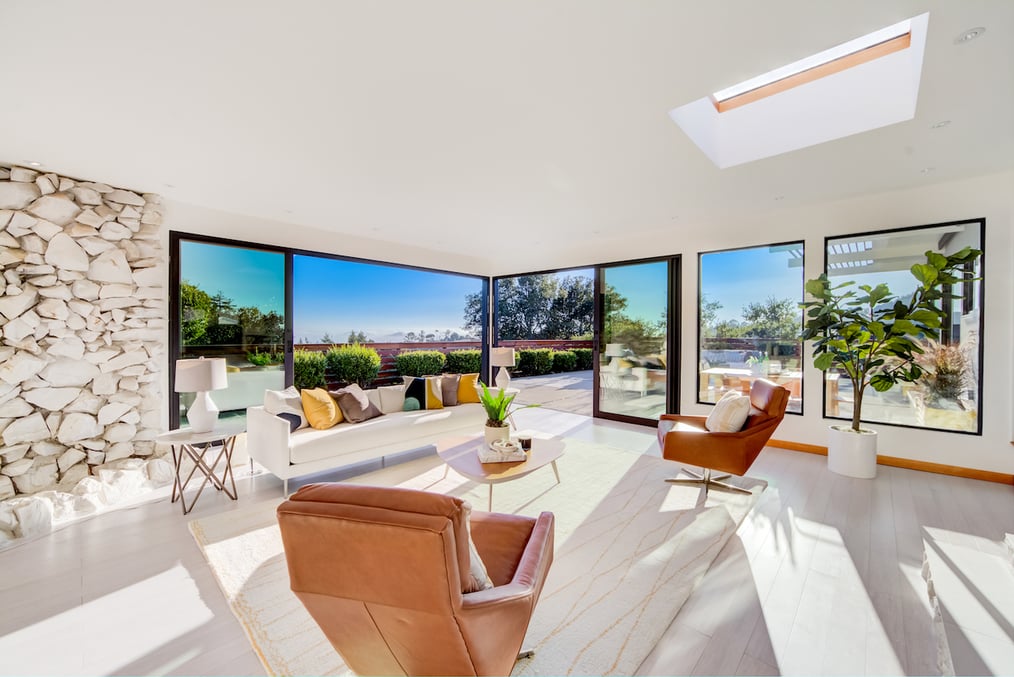 professional real estate photography sample of a luxury home living room looking out large windows and letting in natural light