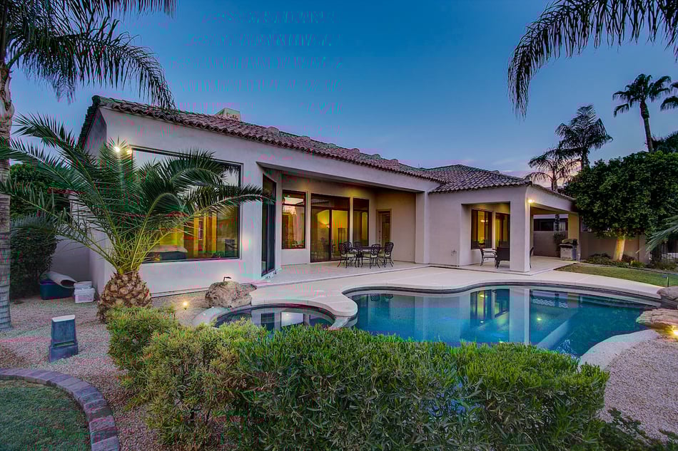 professional real estate photos sample of exterior of home showing a swimming pool in the back yard using twilight photography